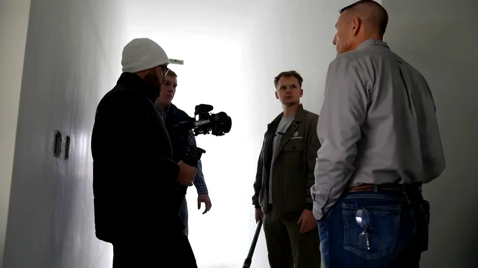 Overcome Media team meeting with a local business owner during a video production