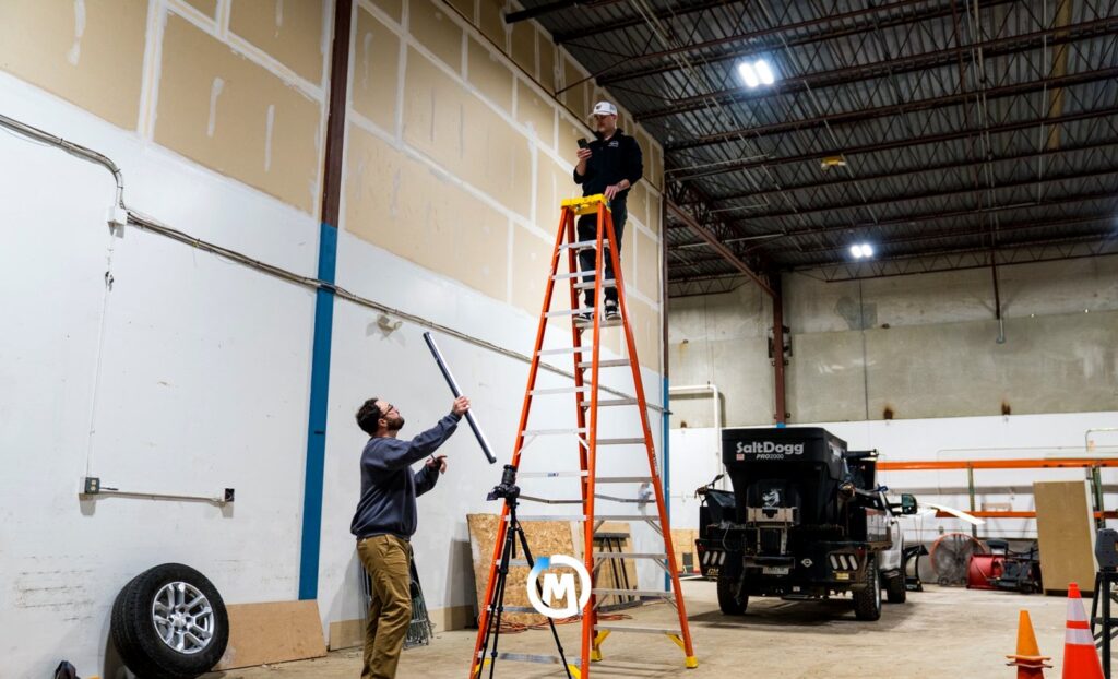 Overcome Media production team setting up lights and camera for a client content shoot